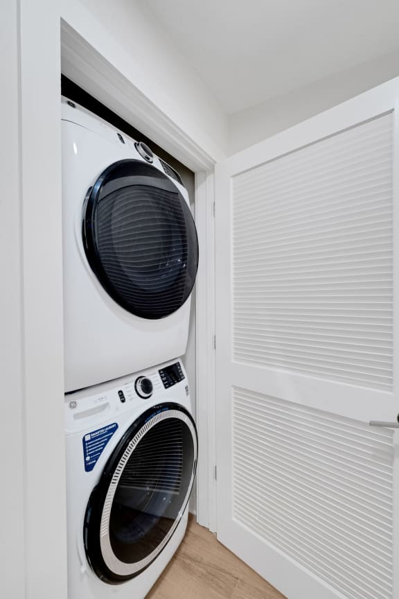 a washing machine and dryer in a small laundry room at Hawkins Press, Charlotte, NC