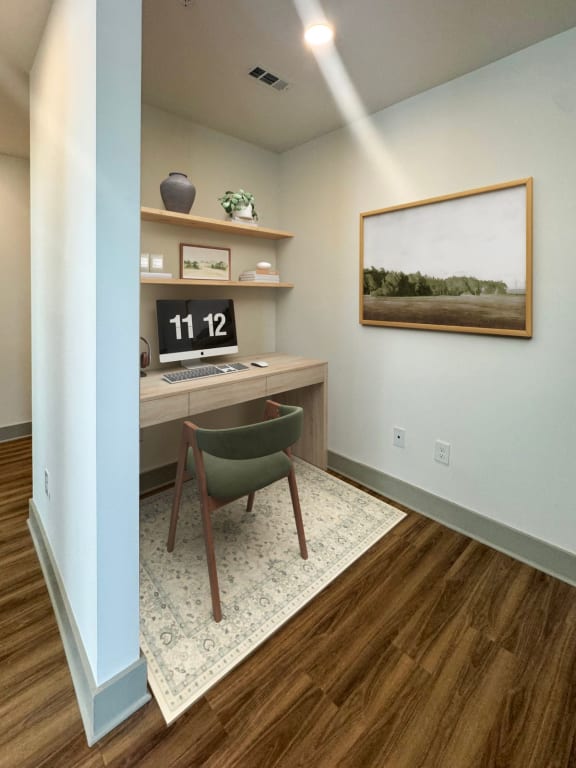 a home office with a desk and a chair and a painting on the wall  at South and Hollis, Charlotte, North Carolina