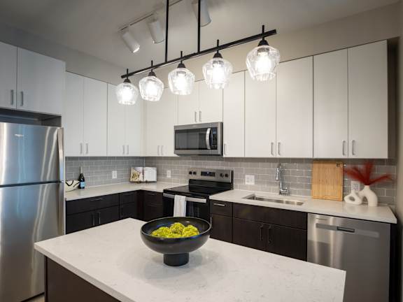 A modern kitchen with a bowl of food on the counter.