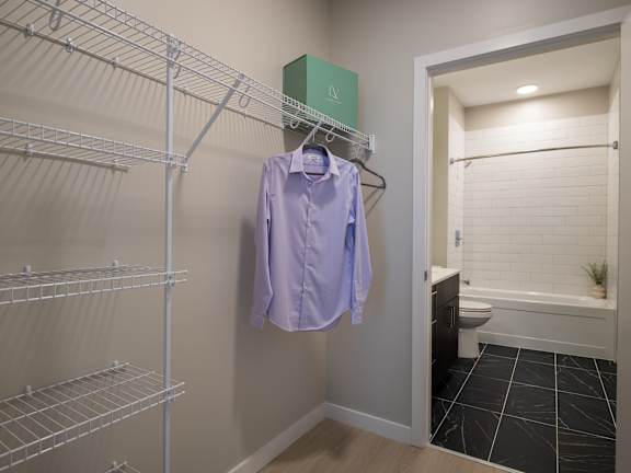 A purple shirt hanging on a rack in a room.