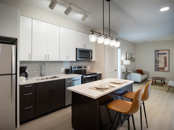 A modern kitchen with a dining table and chairs.