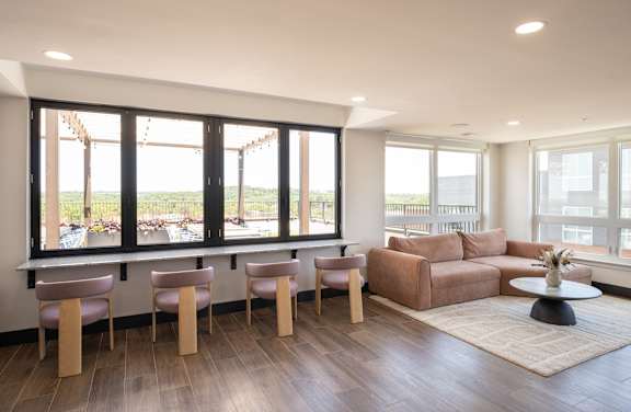 A living room with a couch, chairs, and a table.