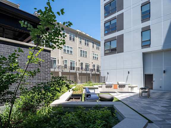 A modern building with a courtyard and a small pond.