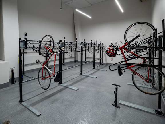 A bike repair shop with bikes hanging from the ceiling.