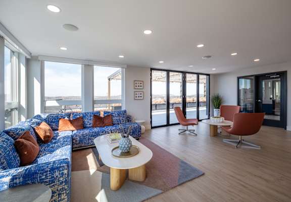 A living room with a blue couch and a white coffee table.
