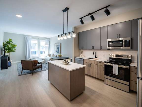 A modern kitchen with a wooden island and stainless steel appliances at Jayde Parkside Apartments, Washington DC