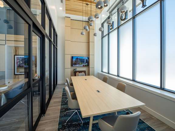 A conference room with a long table and chairs.