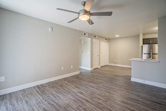 A room with a ceiling fan and wooden flooring at Sterling Point Apartment Homes, Phoenix, AZ