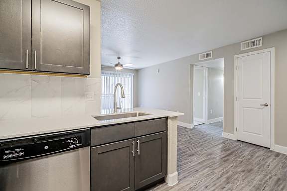 A kitchen with a black dishwasher and a sink with a window above it at Sterling Point Apartment Homes, Phoenix, AZ, 85042