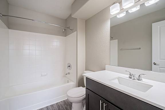 A white bathroom with a toilet, sink, and bathtub at Sterling Point Apartment Homes, Phoenix, AZ, 85042