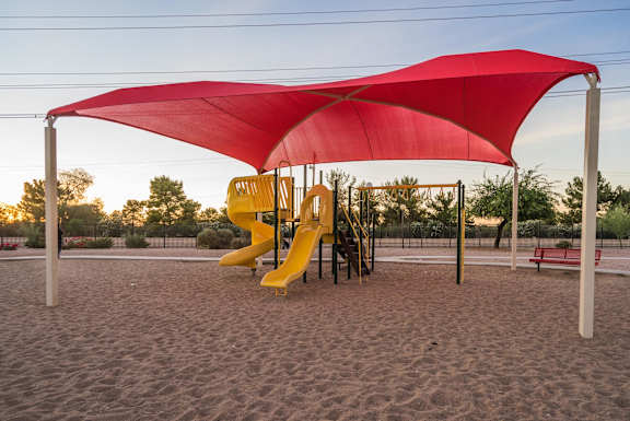A playground with a red canopy and a yellow slide at Sterling Point Apartment Homes, Arizona, 85042