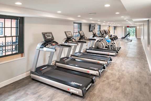 A row of treadmills are lined up in a gym.at The Residences at St. Elizabeths East, Washington