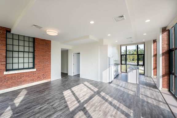 A spacious room with wooden floors and white walls.at The Residences at St. Elizabeths East, Washington District of Columbia