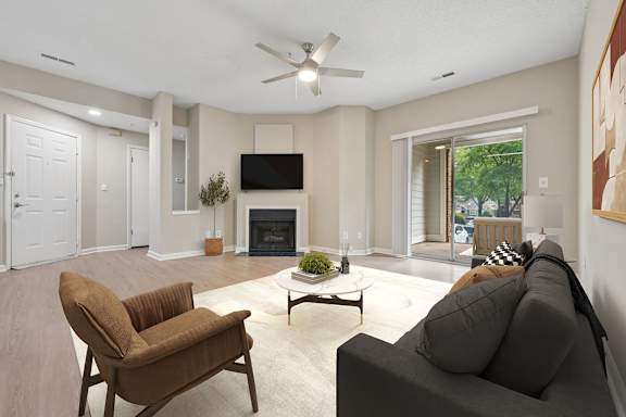 A living room with a brown chair and a grey couch.
