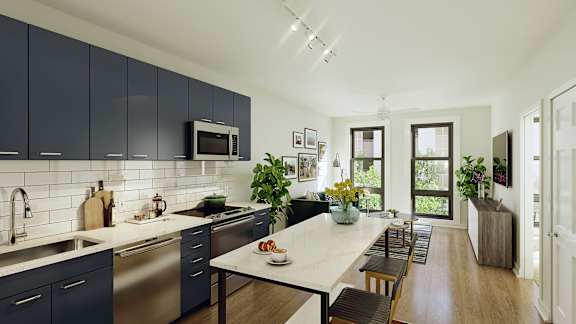 A modern kitchen with dark blue cabinets and a white countertop.
