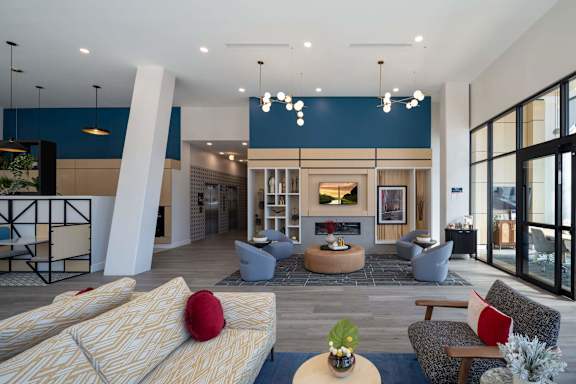 A modern living room with a fireplace and a large window at Jayde Parkside Apartments, Washington 20019