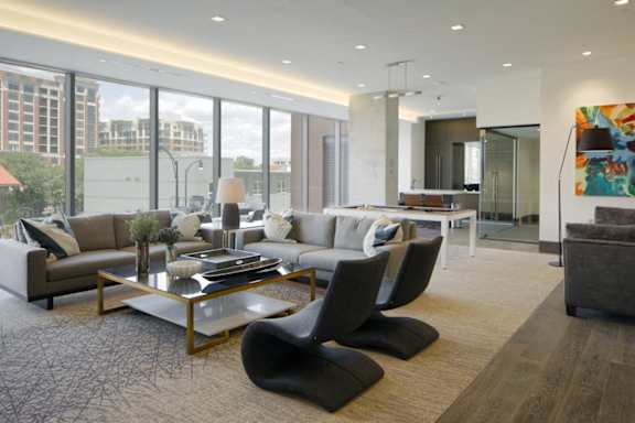 Contemporary living room with glass coffee table and sectional at 1305 Dock Apartments, Baltimore, 21231