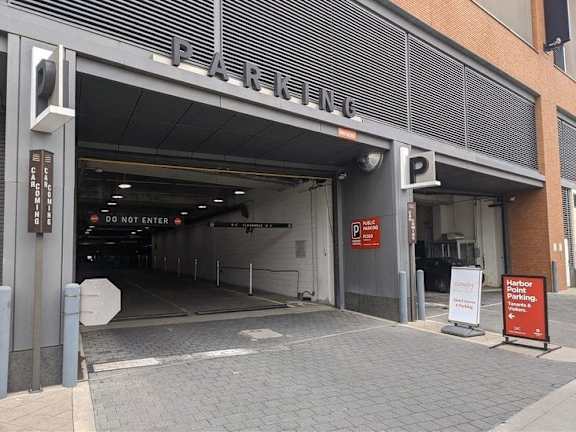 Parking garage entrance with modern metal canopy at 1305 Dock Apartments, Baltimore, Maryland
