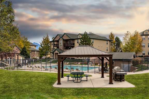 A covered picnic area with a pool at Sunset Ridge, West Jordan, 84081