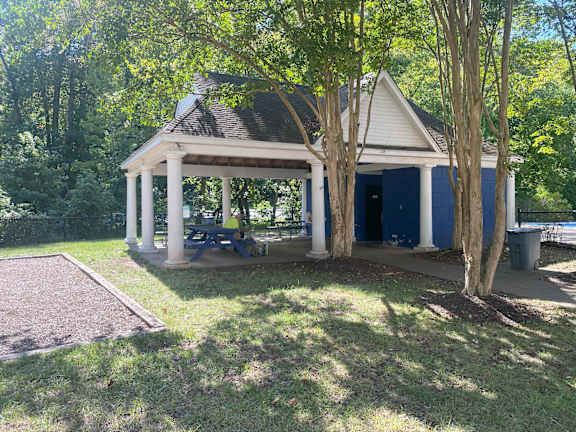 A small house with a blue door and white columns.
