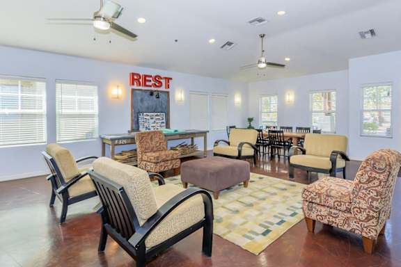 A living room with a sign that says "RIEST" on the wall.