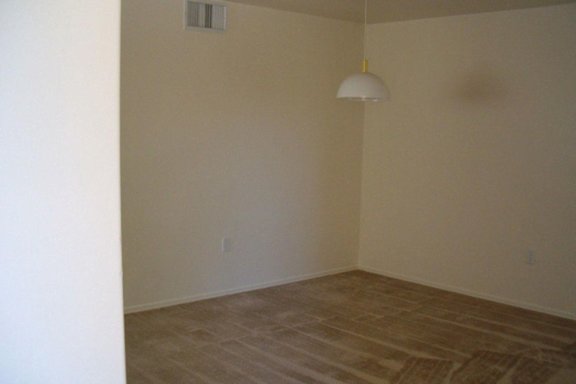 A room with a light hanging from the ceiling.