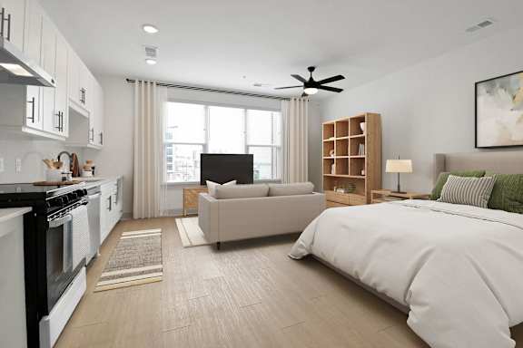 a bedroom and living room with a bed and a window at Metropolitan at the Riverwalk, Wilmington, NC