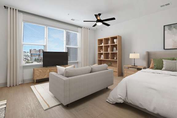 a bedroom with a bed and a couch and a tv at Metropolitan at the Riverwalk, Wilmington, NC