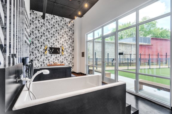 a bathroom with a tub and a large window at South and Hollis, North Carolina, 28209