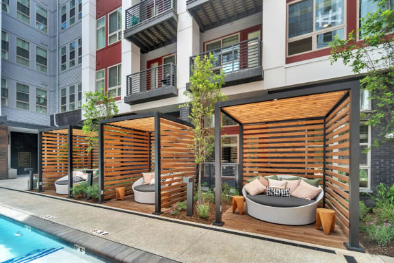 a communal area with a pool and a city building