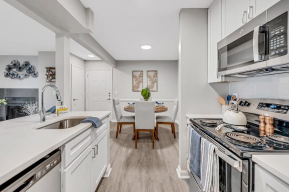 a kitchen with white cabinetry and stainless steel appliances at Brampton Moors, North Carolina, 27513
