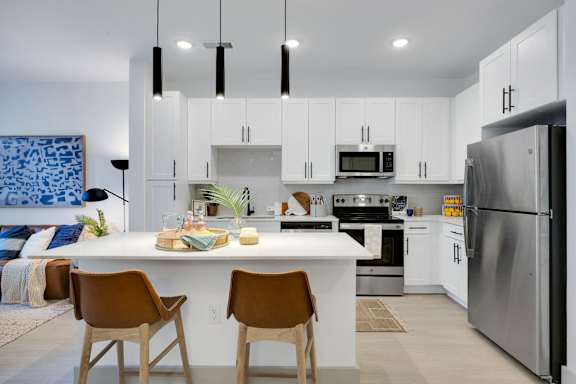 A modern kitchen with a dining table and chairs.
