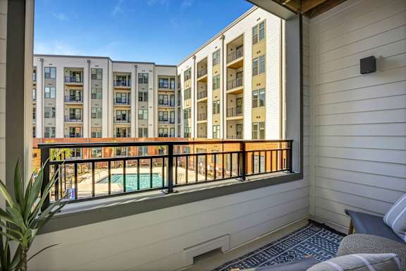 A balcony with a pool and a pineapple plant.