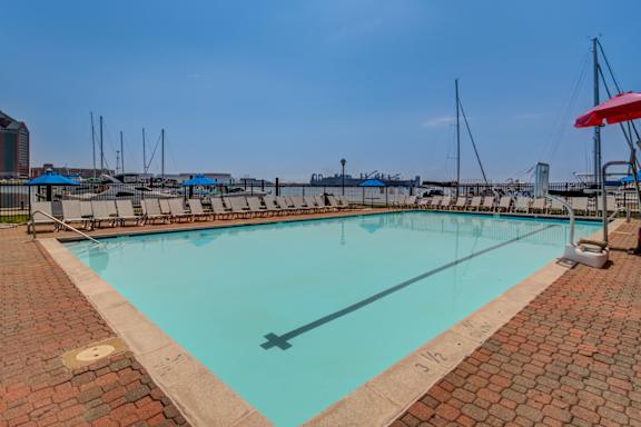 a swimming pool with a view of the harbor and the city at Tindeco Wharf, Baltimore, MD 21224