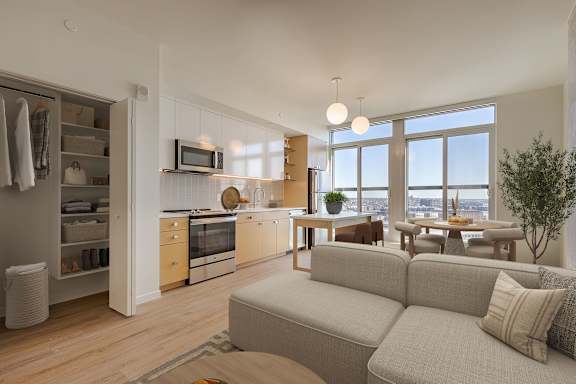Modern apartment living room with kitchen island at Allied Harbor Point Apartments, Baltimore, 21231