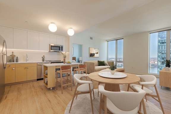 Open concept living area with dining table at Allied Harbor Point Apartments, Baltimore, Maryland