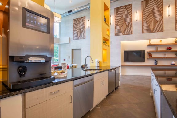 a kitchen with stainless steel appliances and a counter top at Woodmore Grand Apartments in Bowie, MD 20721