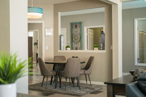 A dining room with a table and chairs at West Park Apartments, New Mexico 87114