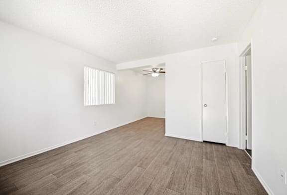 A room with a wooden floor and white walls.
