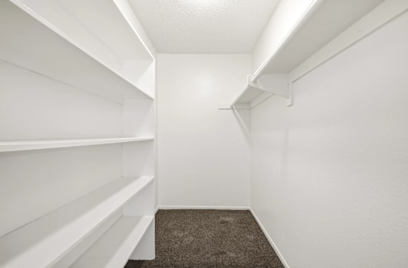 Empty white shelves in a room.