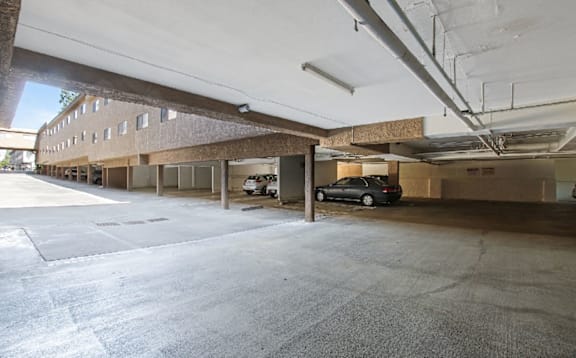 A parking garage with a car parked in the middle.