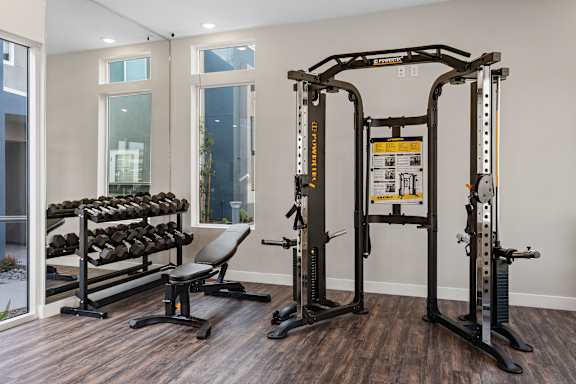 a gym with free weights and weight machines at Loma Villas Apartments, San Bernardino, CA