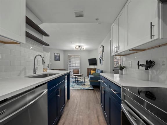 a kitchen with blue cabinets and stainless steel appliances at 505 Collection, Atlanta, GA, 30305