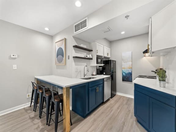 a kitchen with blue cabinets and a counter top at 505 Collection, Atlanta, GA, 30305