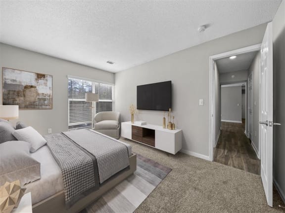 a bedroom with a large bed and a tv