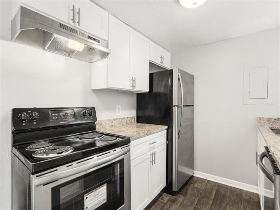 a kitchen with stainless steel appliances at Pinewood Townhomes in Tucker, GA 30084