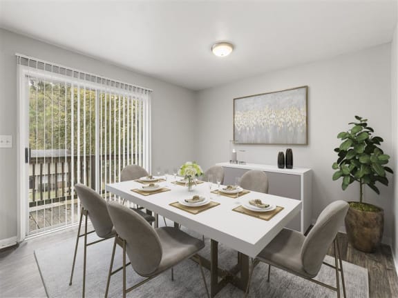 a dining room with a table and chairs at Pinewood Townhomes in Tucker, GA 30084
