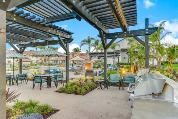Spacious Patio/ Balcony with tables and chairs and a grill