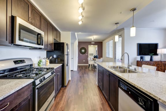 Full kitchen with granite counter tops and stainless steel appliances at SETA, La Mesa, CA, 91942