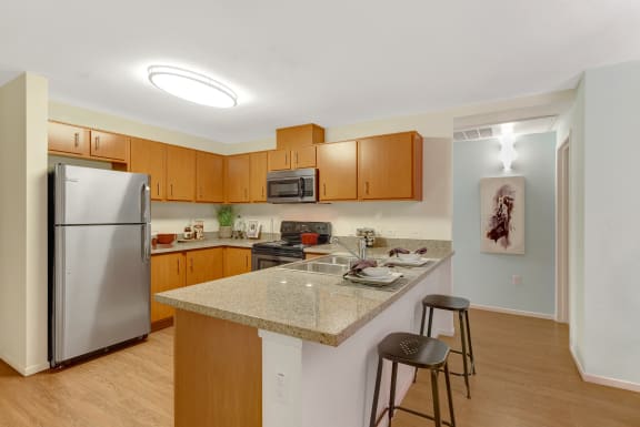 a kitchen with granite counter top and stainless steel appliances